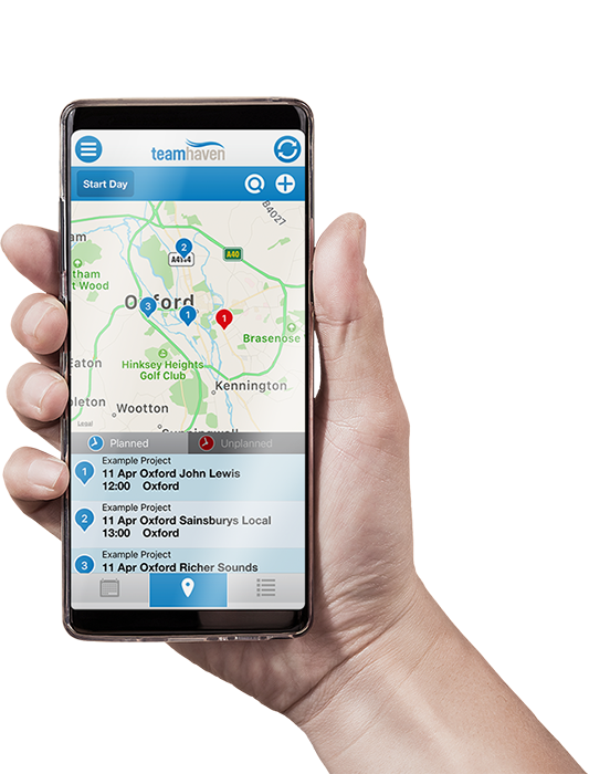 Hand holding phone showing map on TeamHaven Mobile app